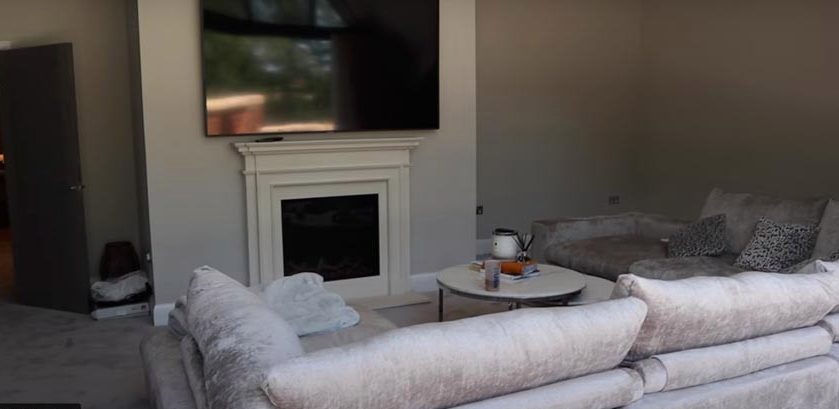  The huge grey sofas are centred around a gas fireplace