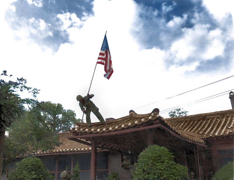  A US marine raising the United States flag above the American consulate in Seoul