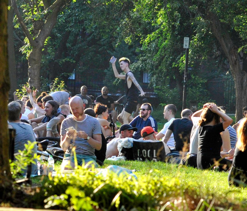 Crowds gather at a park in Manchester city centre