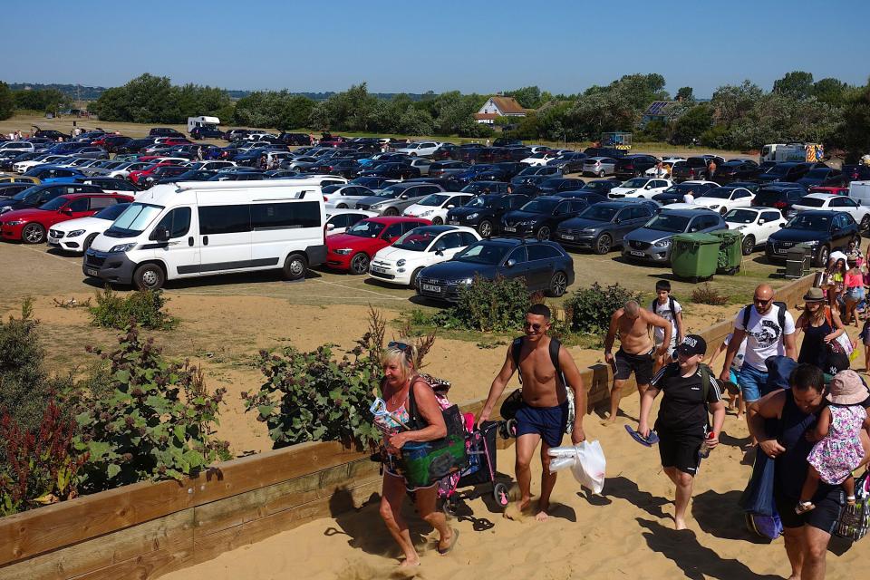 Beachgoers make their way to the shore at Camber Sands beach