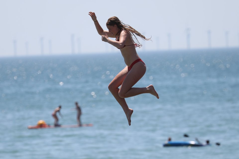 A swimmer jumps into the water at Brighton