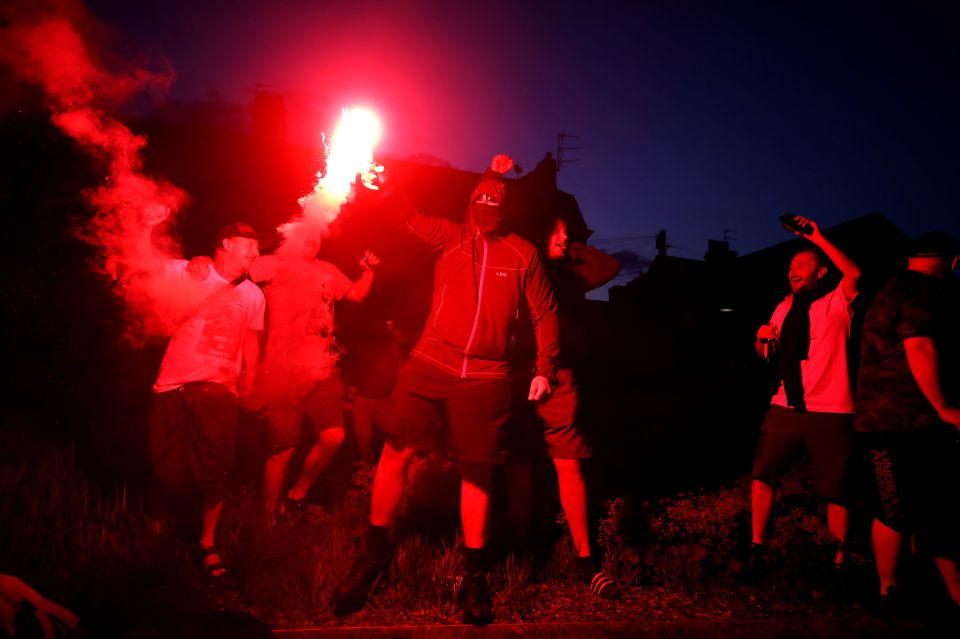 Liverpool fans let off flares outside Anfield after winning the Premier League title tonight