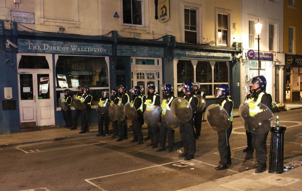 Police in full riot gear trying to disperse crowds in Notting Hill