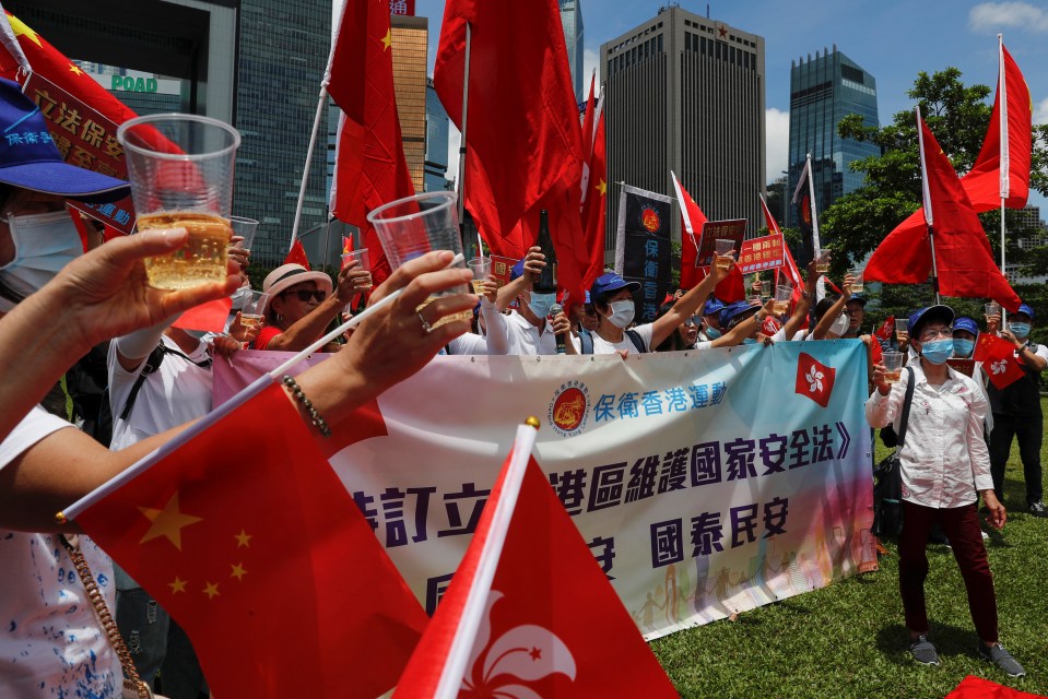 Pro-China supporters celebrate with champagne after China’s parliament passes national security law for Hong Kong