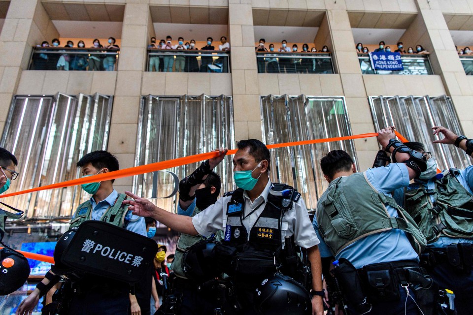 Police enter a shopping mall to disperse a peaceful rally in Hong Kong today