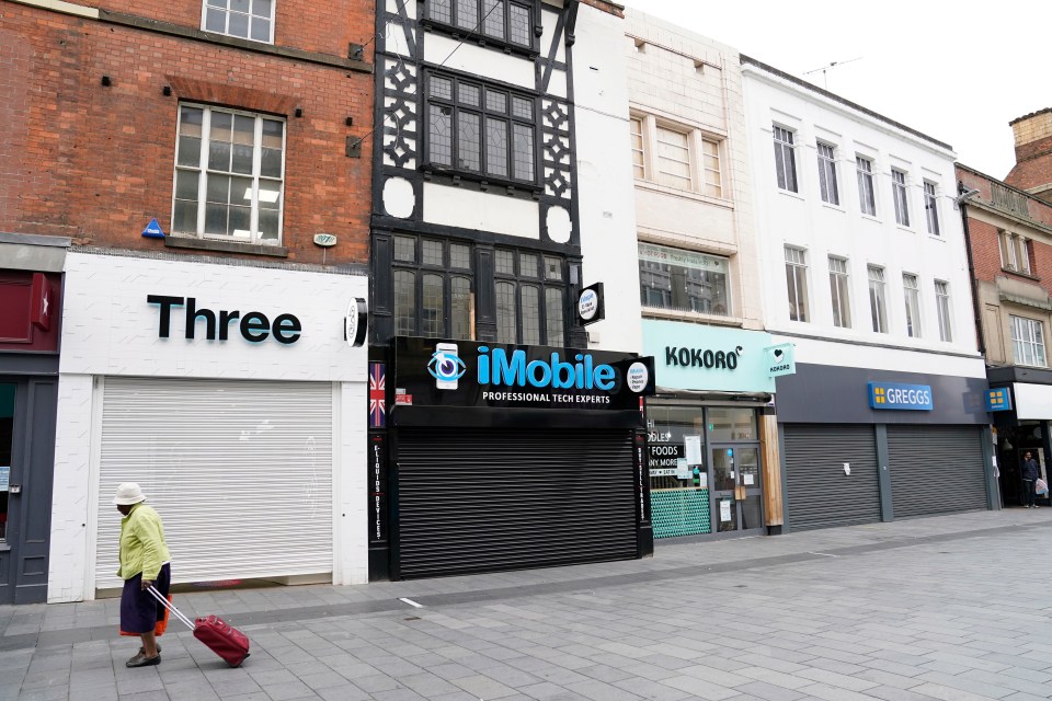 A woman walks through the deserted streets of Leicester after the lockdown was announced