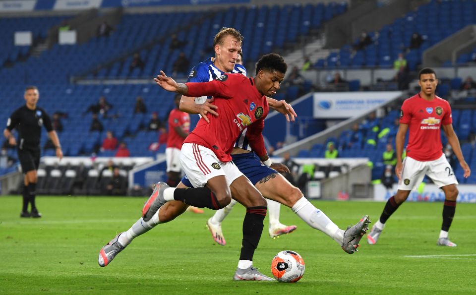  Man United's Marcus Rashford goes down under the challenge from Brighton defender Dan Burn