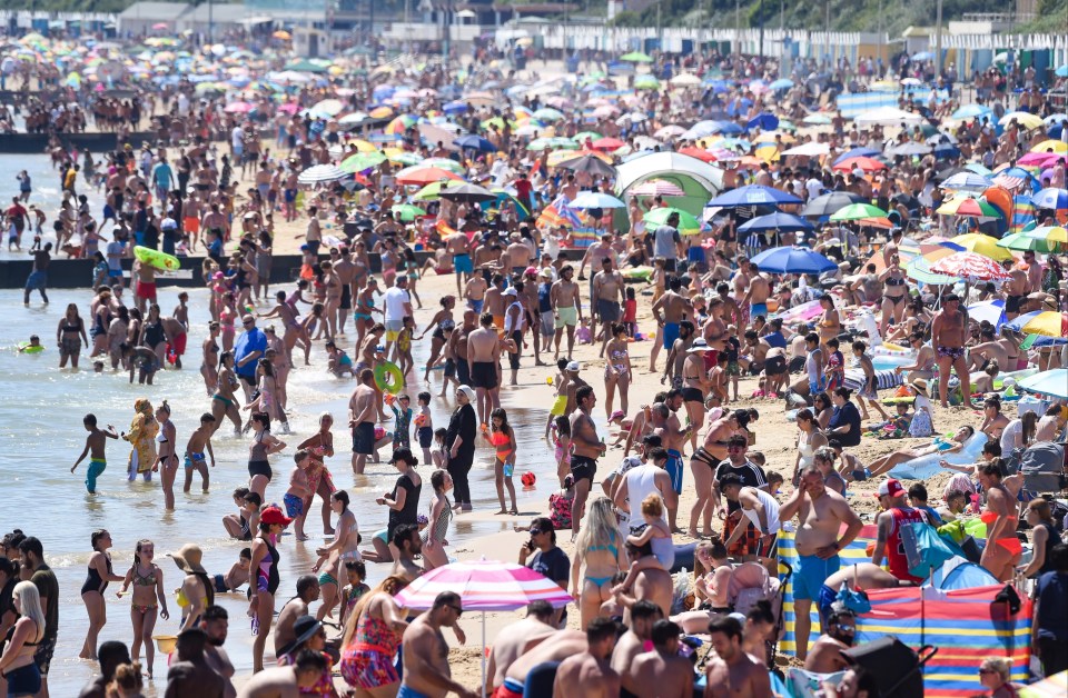 Crowds enjoy the warm weather at Bournemouth beach