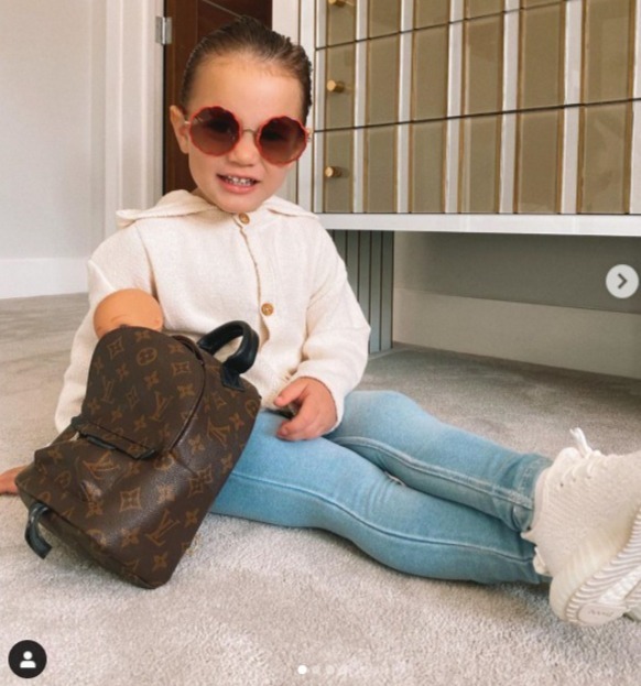 Here Rosie models her £1,500 Louis Vuitton backpack with her £115 Chloe sunglasses