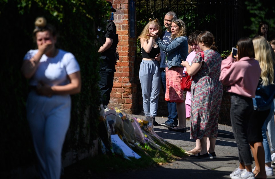 Students and parents lay flowers and pay their respects to the murdered school teacher James Furlong outside The Holt School