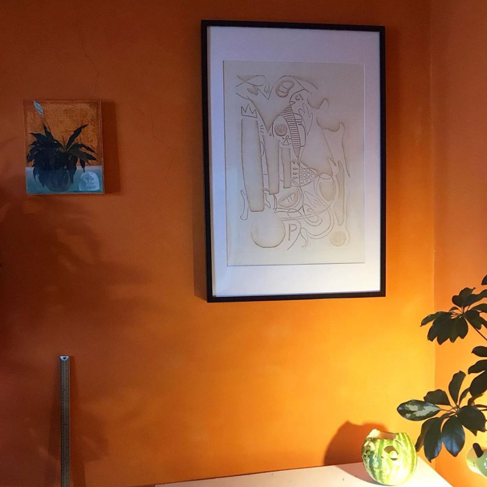  The Salford lass has plumped for bright orange walls featuring her own artwork