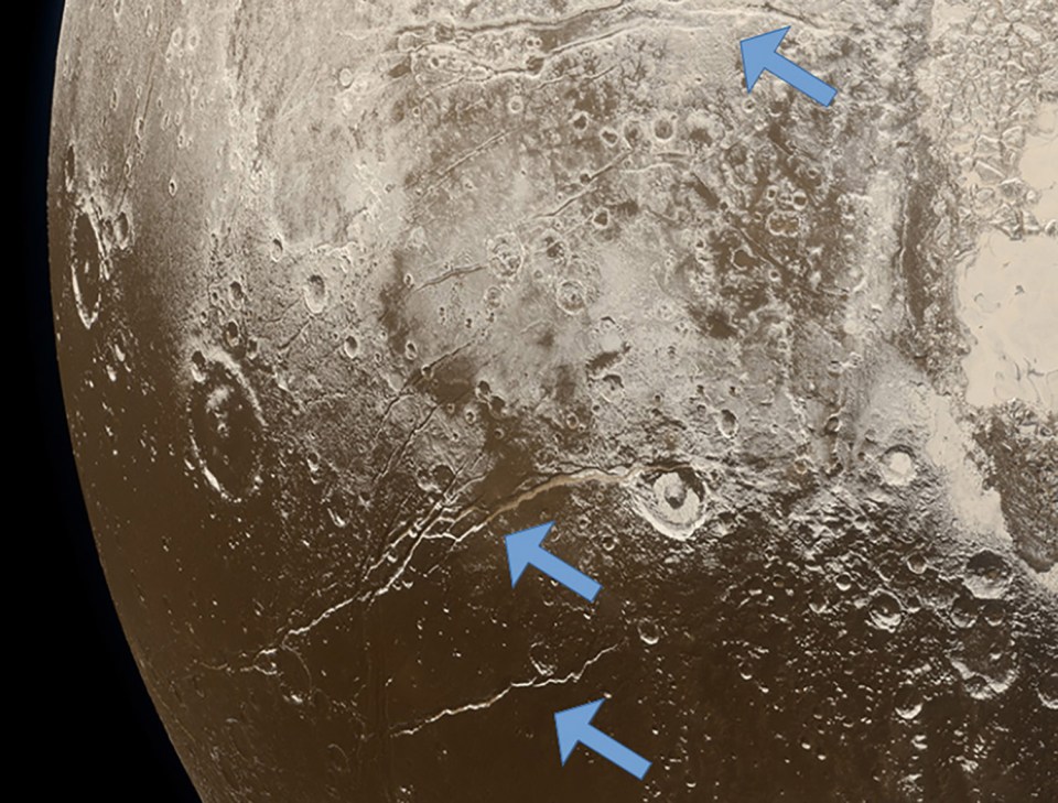 This image shows “extension faults” that indicate a subsurface ocean is freezing below the icy crust