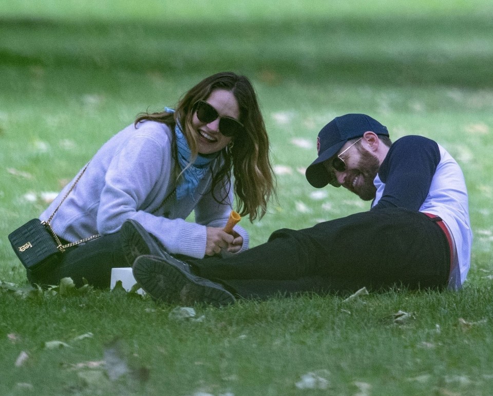 Lily laughed along with Chris while clutching the remains of a cone