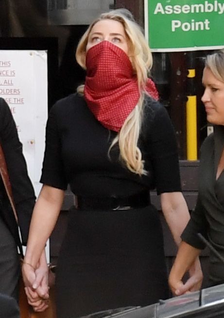 Heard covered her face with a scarf as she arrived in London