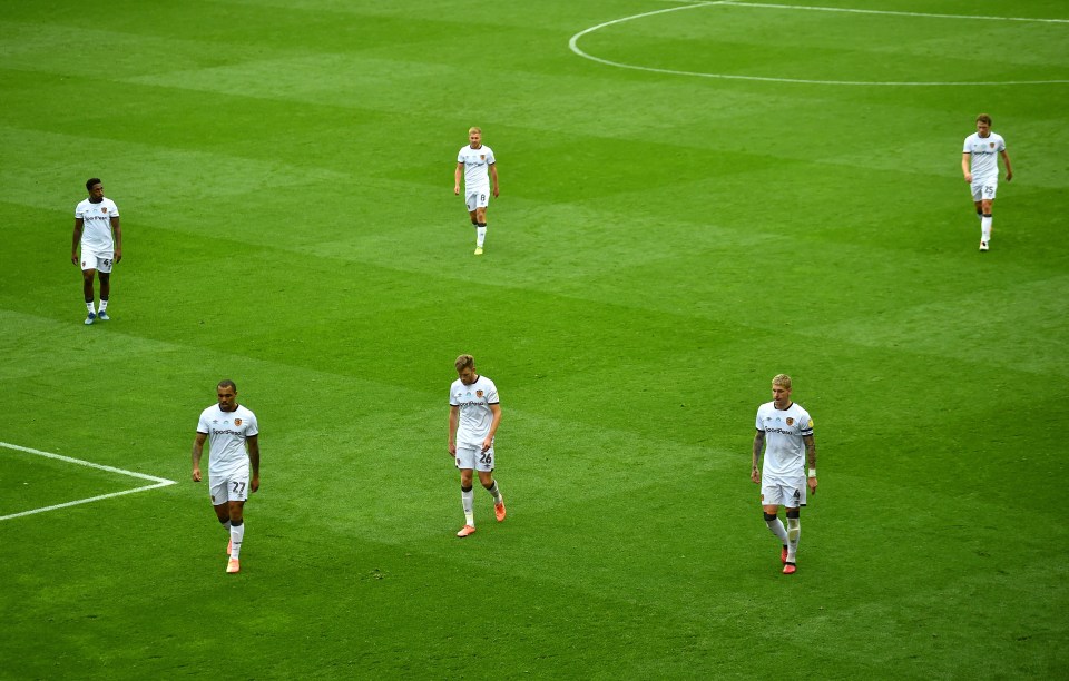 Hull players walk off dejected at the half-time whistle