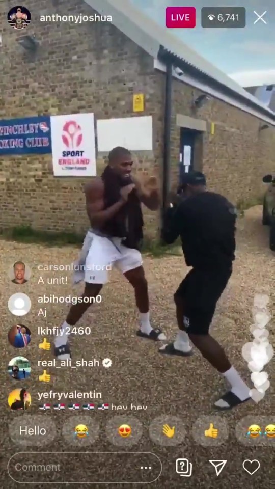 Anthony Joshua was captured having a touch spar with local lads after finishing his own session