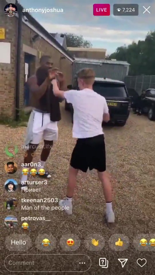 Joshua was filmed having a down to earth moment with some fans outside the Finchley Amateur Boxing club