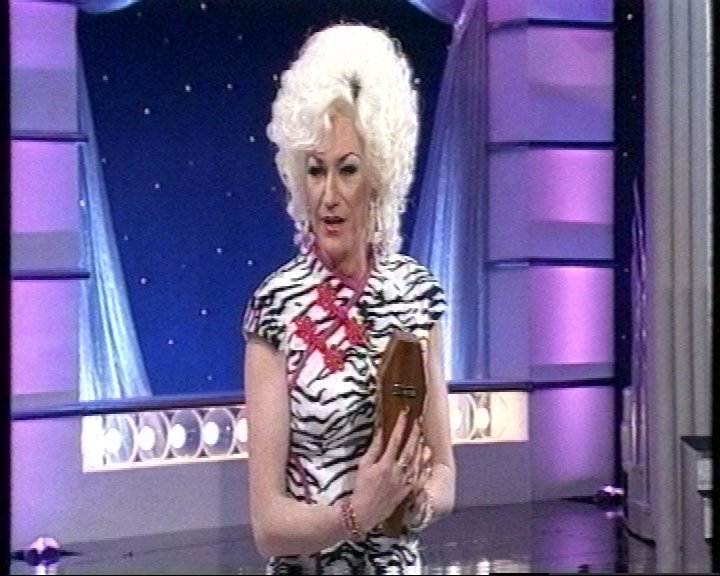 Paul worked in comedy clubs before landing a gig as Lily on Blankety Blank in 1998