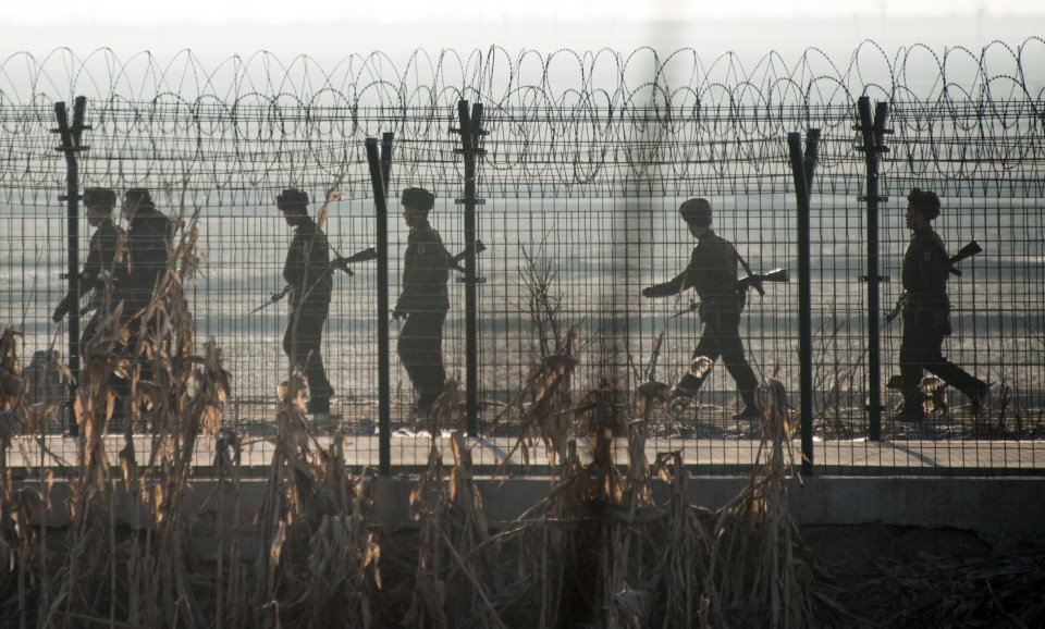 North Korean soldiers patrolling along the border with China - Chinese authorities hand over North Korean defectors to their homeland's penal system