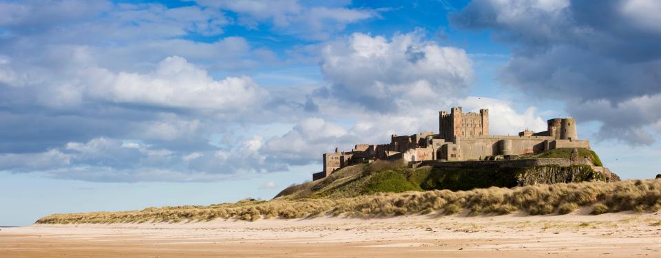 The stunning view of Bamburgh Castle from Wynding beach in Northumberland 