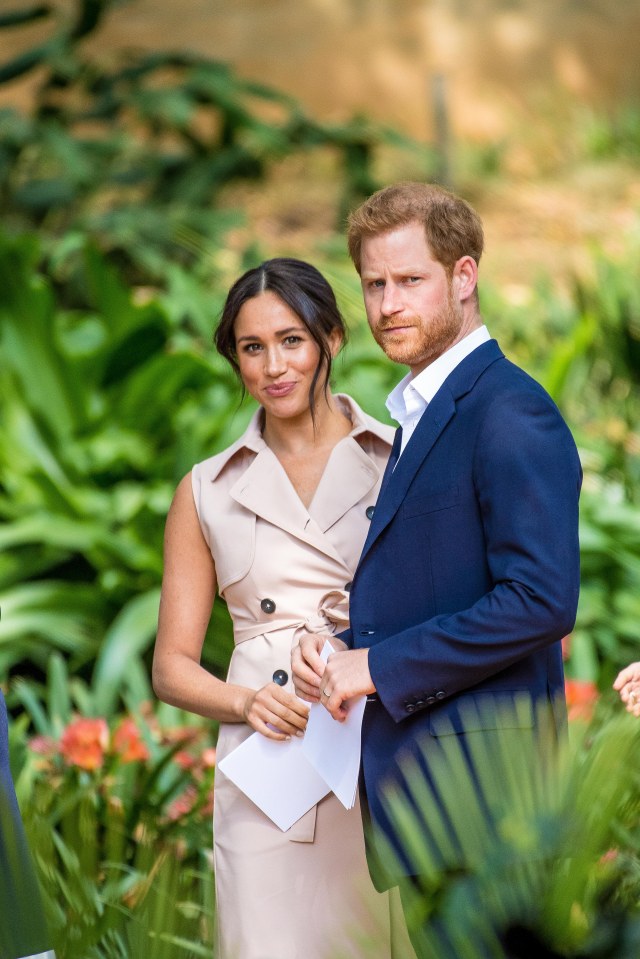 Prince Harry looking unimpressed at the camera as a picture is taken