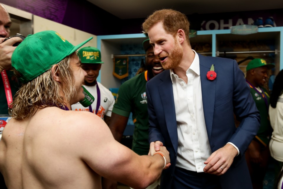 Prince Harry shakes hands with De Klerk in the dressing room after the Springboks beat England in Japan