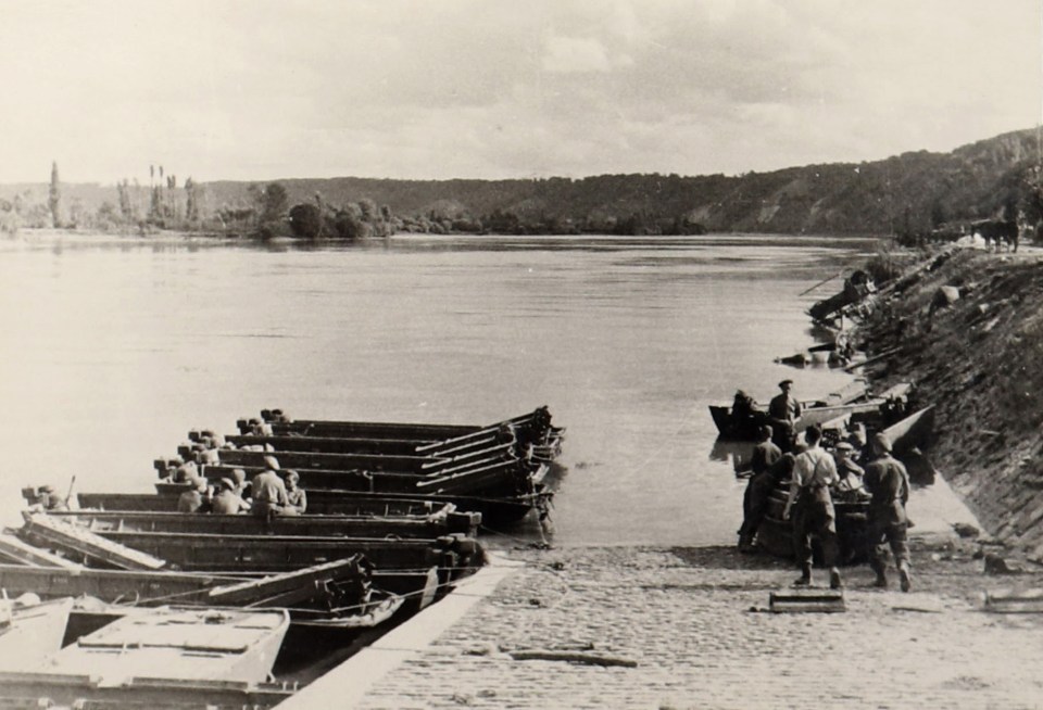 British forces use storm boats to secure a ferry site along the Normandy coast