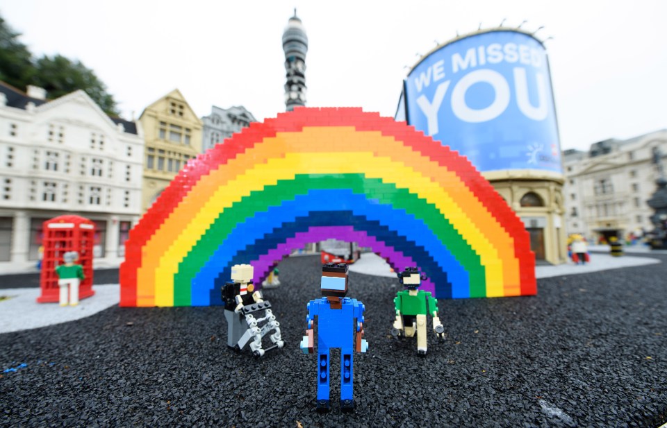 The scene depicts the NHS rainbow in London's Piccadilly Circus