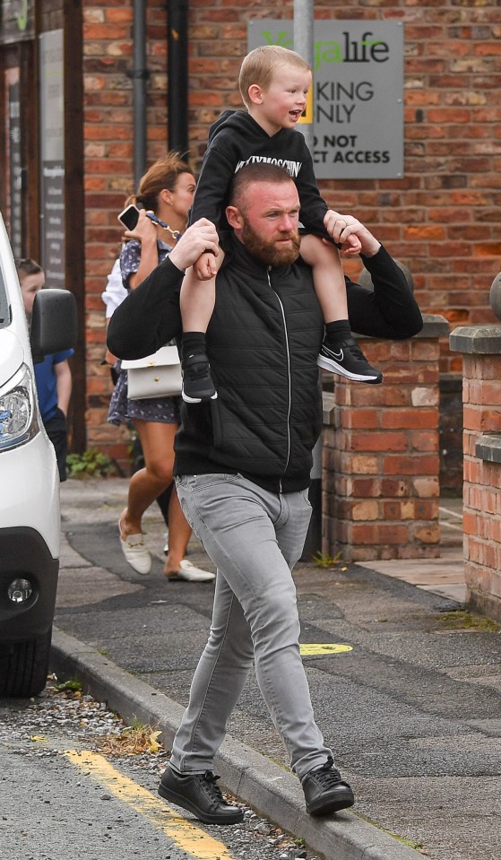 Wayne Rooney was spotted shoulder-carrying his son Kit while out and about