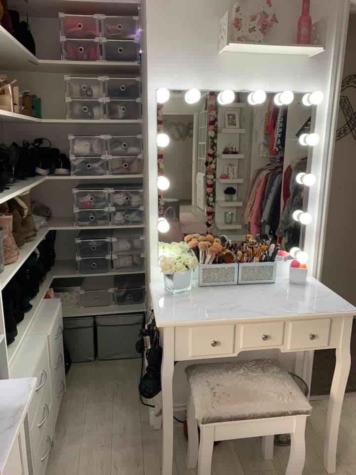 The dressing table has a marble finish and Hollywood-style mirror