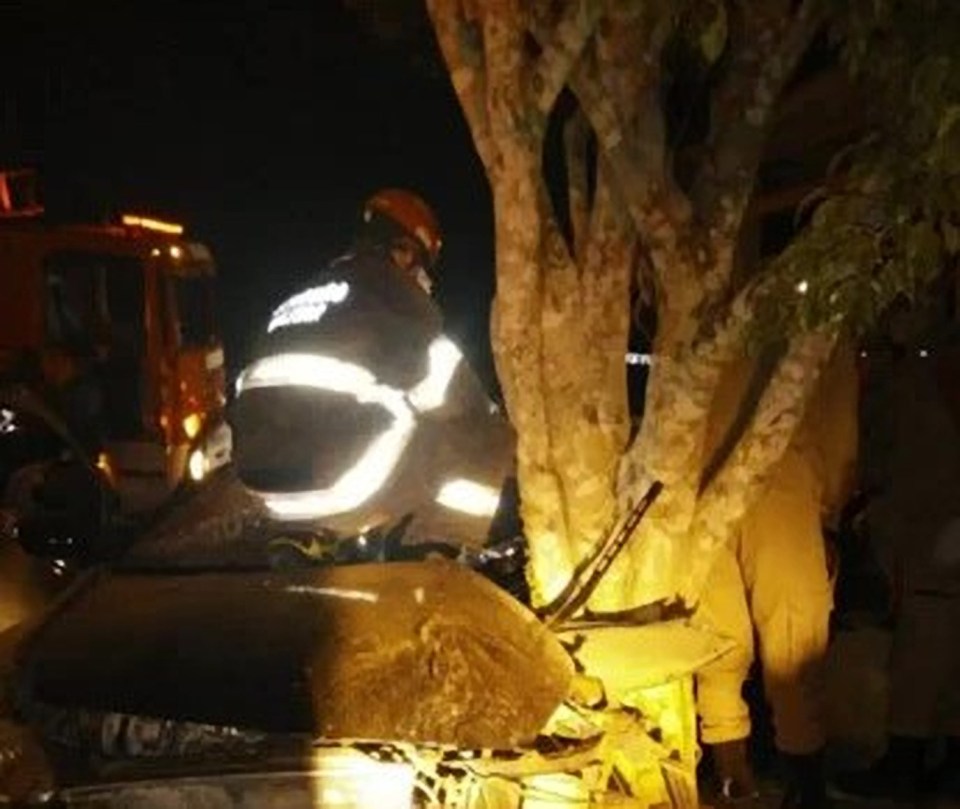 Rescuers work on Sampaio's car after the crash