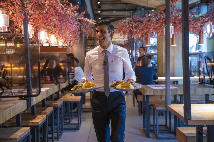 Chancellor Rishi Sunak handing out meals to customers at a Wagamama restaurant