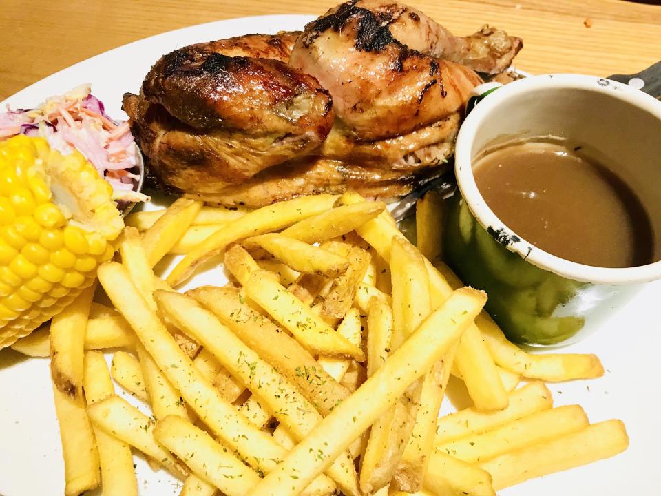 Harvester pub chain rotisserie chicken and fries with gravy, and corn on the cob