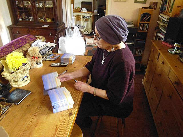 Judy pictured signing album covers of Weavings of a Silver Magic in March