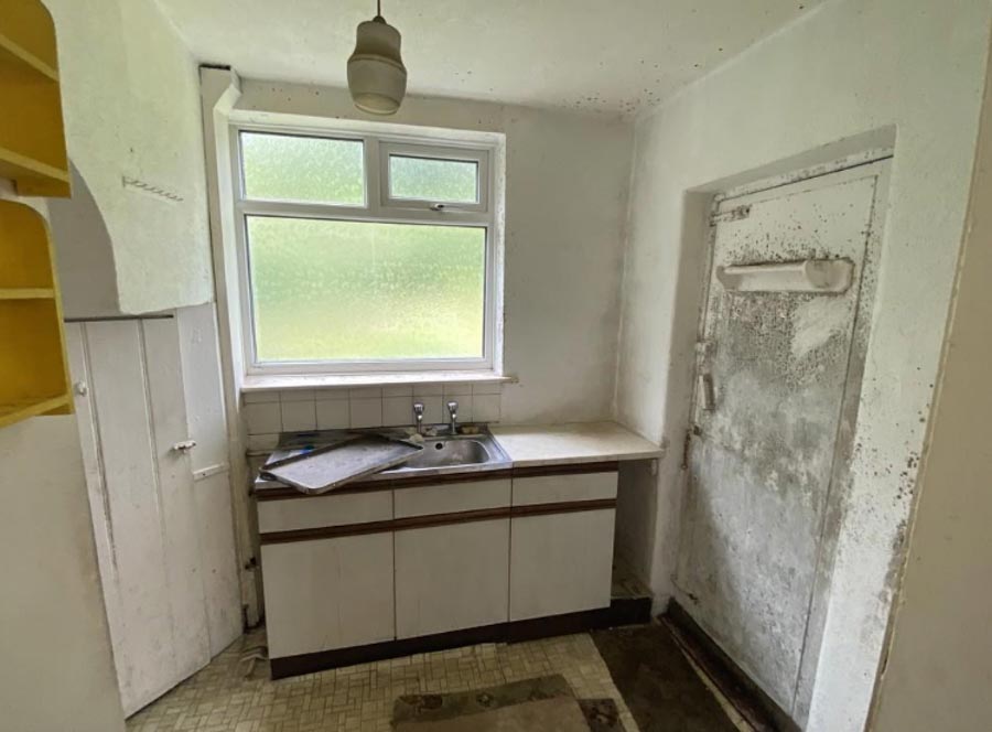 The kitchen needs a new sink and a replacement for its grim mouldy door