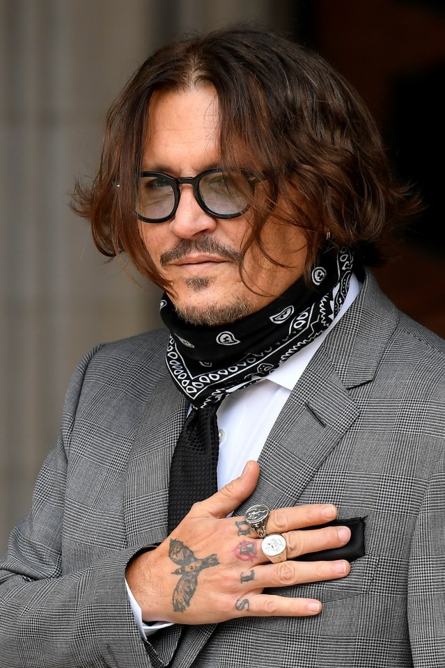 Depp's hand tattoos were shown as he put his hand to his chest