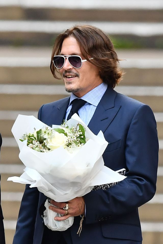 Depp pictured with the flowers given to him this afternoon