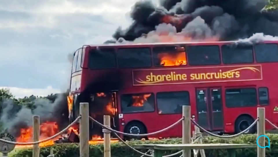 A double-decker was engulfed in flames after a head-on motorbike crash