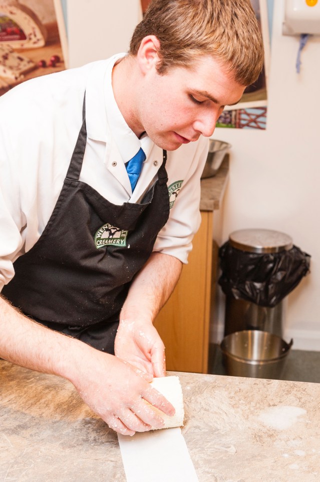 A man demonstrates how to make cheese in the Wensleydale Creamery visitor centre in Hawes in Wensleydale, North Yorkshire