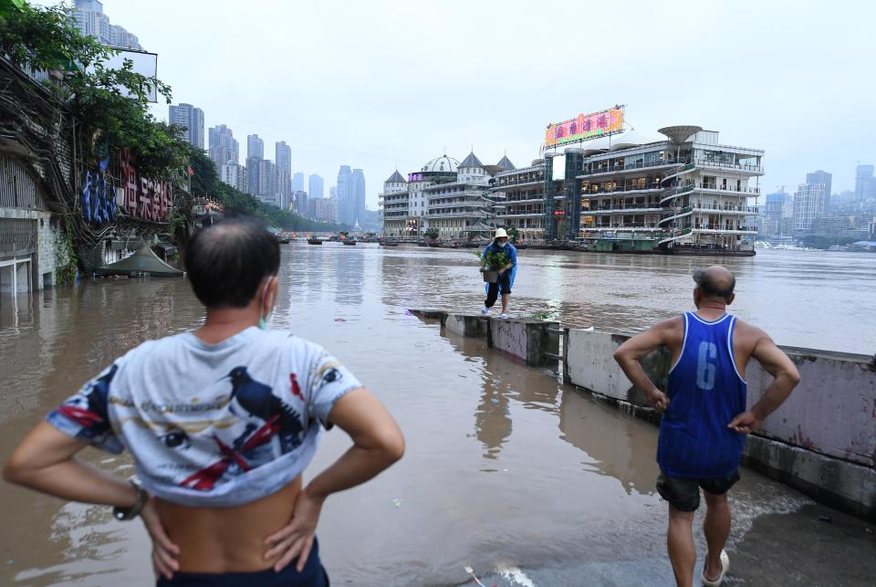 Chongqing locals battle rising flood water on the banks of the Yangtze River 