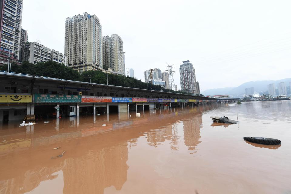 Shops are partially submerged in flood waters on the banks of the Yangtze River as a flood peak passes through the area