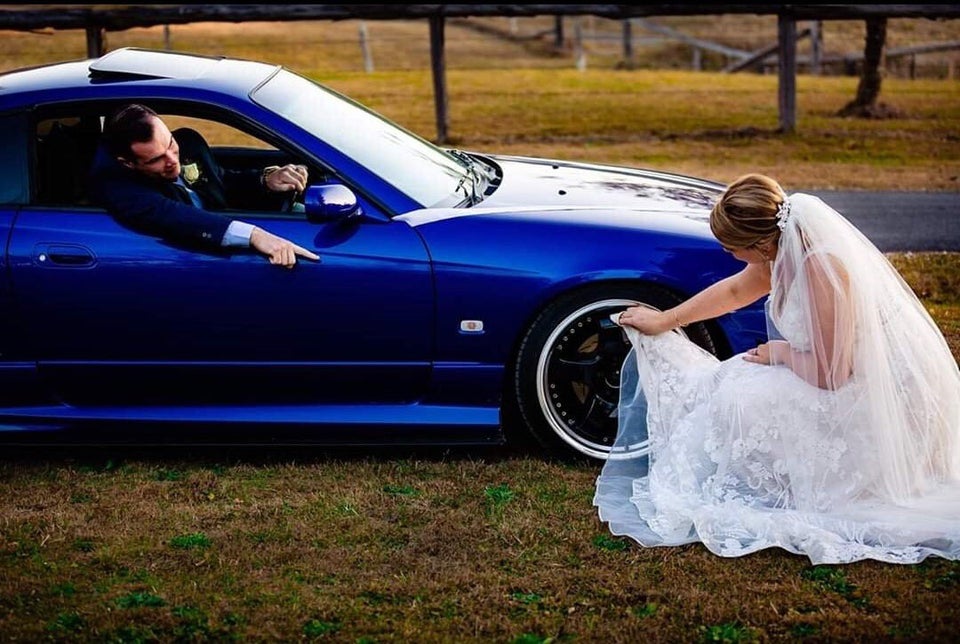 The bonkers snap shows the bride scrubbing the wheel with her dress