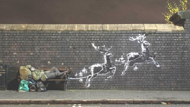 Banksy filmed a homeless man named Ryan sleeping on the bench next to his reindeer mural in Christmas 2019