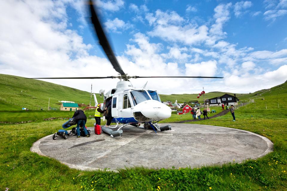 A helicopter arrives at remote Mykines Island