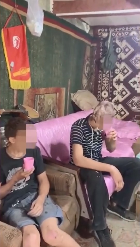 The boys after their rescue in Ukraine, drinking water after they were found dehyrated