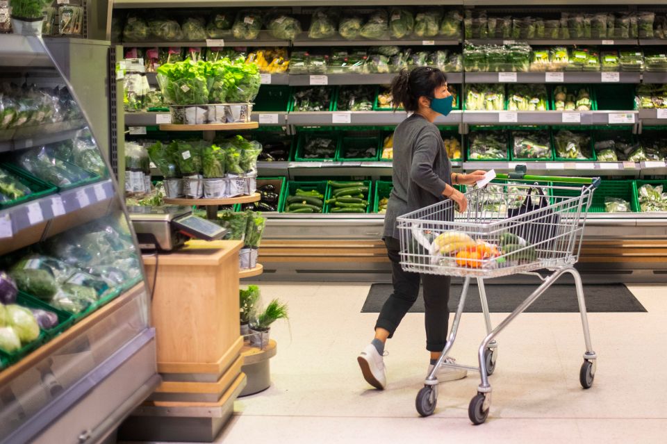 A woman covering up in a supermarket in East London as the laws changed today