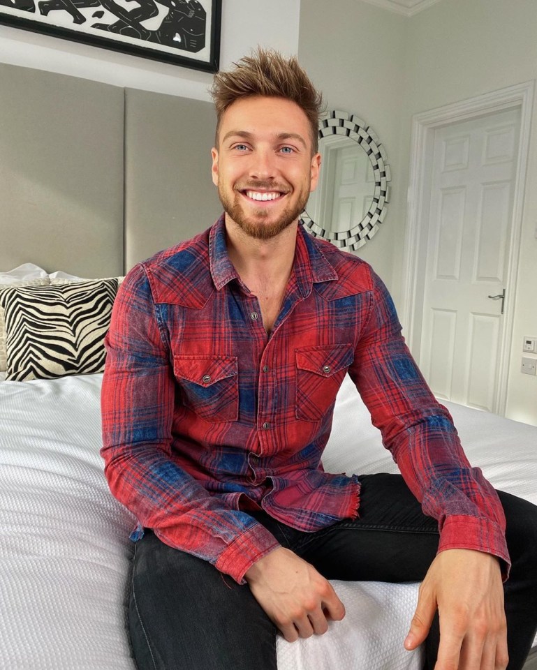 Sam, 28, poses in front of a modern circular mirror in the pair's minimalistic bedroom