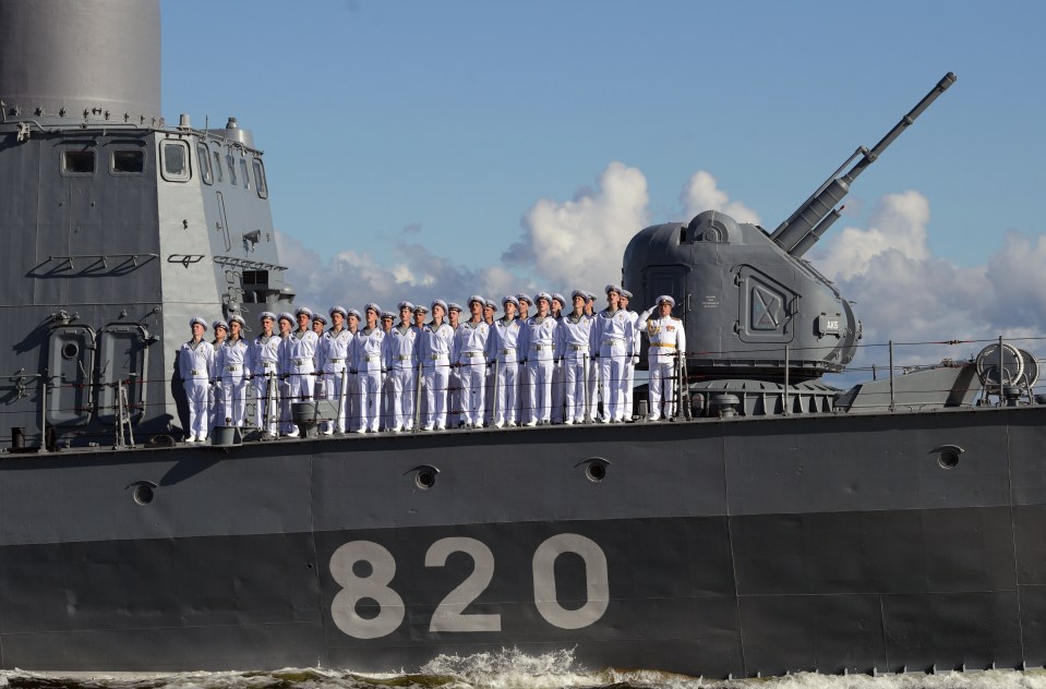 Russian sailors stand to attention as they sail on Navy Day