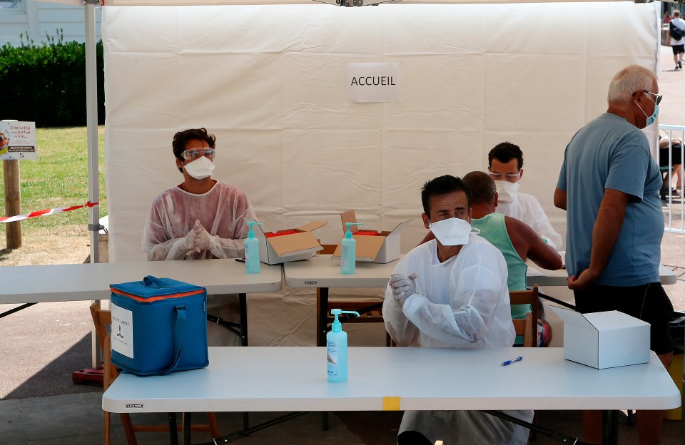 Medics mask up as they prepare to test beachgoers in France