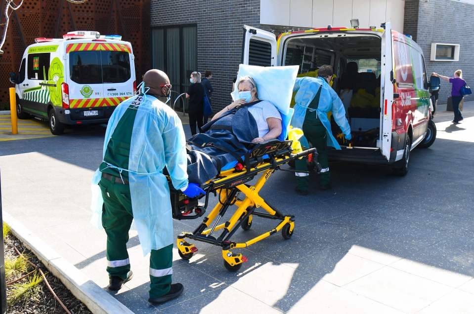 Ambulance officers transport a resident from the Epping Gardens aged care facility